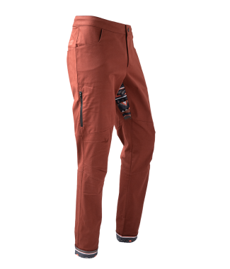 Rock pants in rust red for climbing with stretch panel in native red and zip pocket above knee